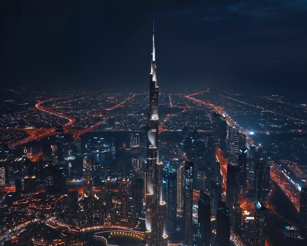 The Burj Khalifa seen from the air at night, lit from base to spire